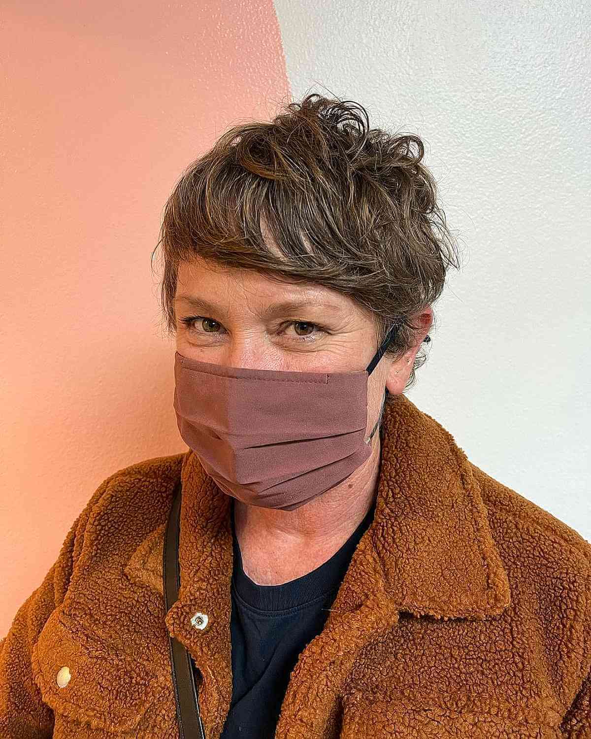 Tousled Pixie Shag Featuring Side-Swept Bangs for an Older Woman