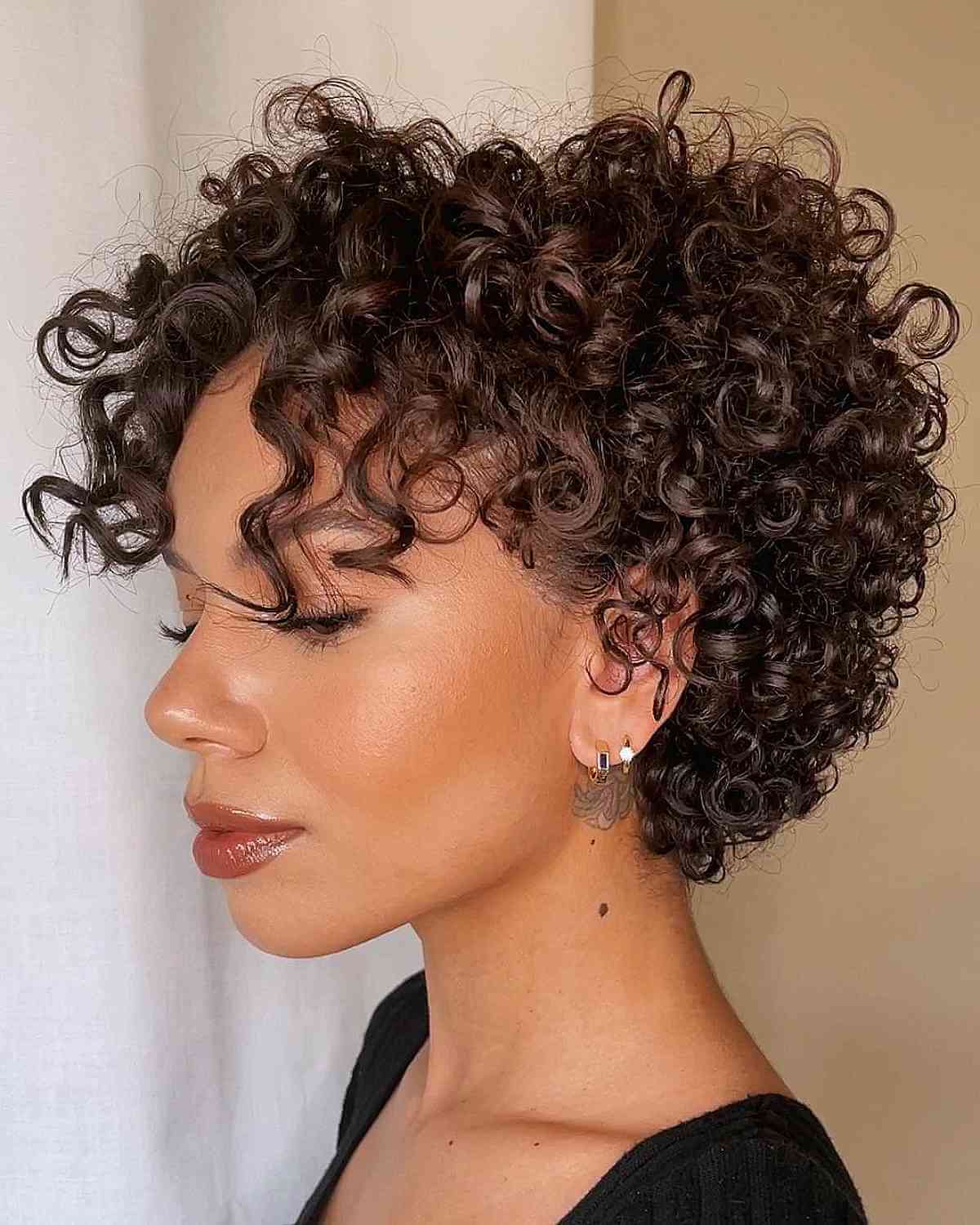 Chic pixie cut featuring curly bangs