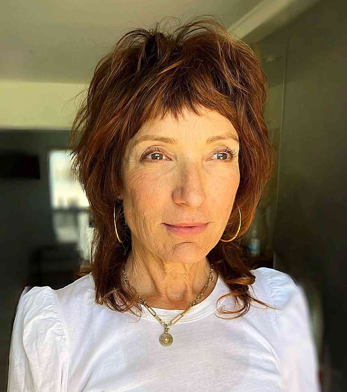 Trendy Shaggy Wolf Cut with Bangs for Mature Women with dark copper hair color