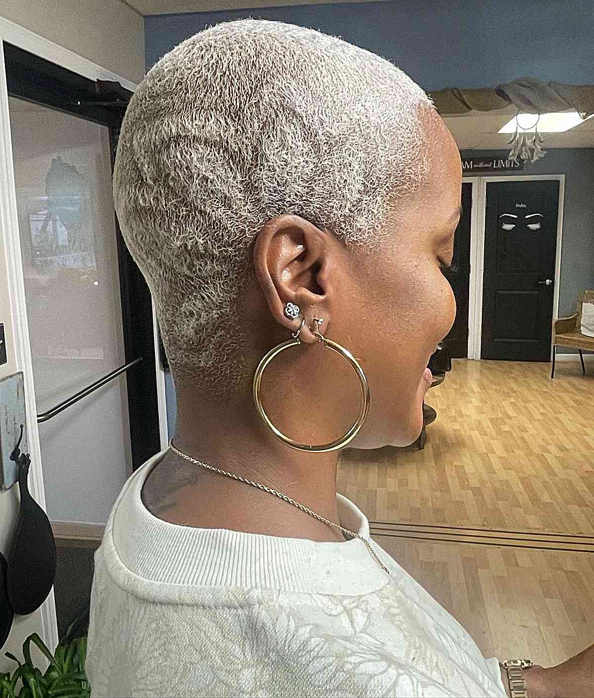 Ultra Short Buzz Cut with Platinum Shade and Shaved Flower Pattern