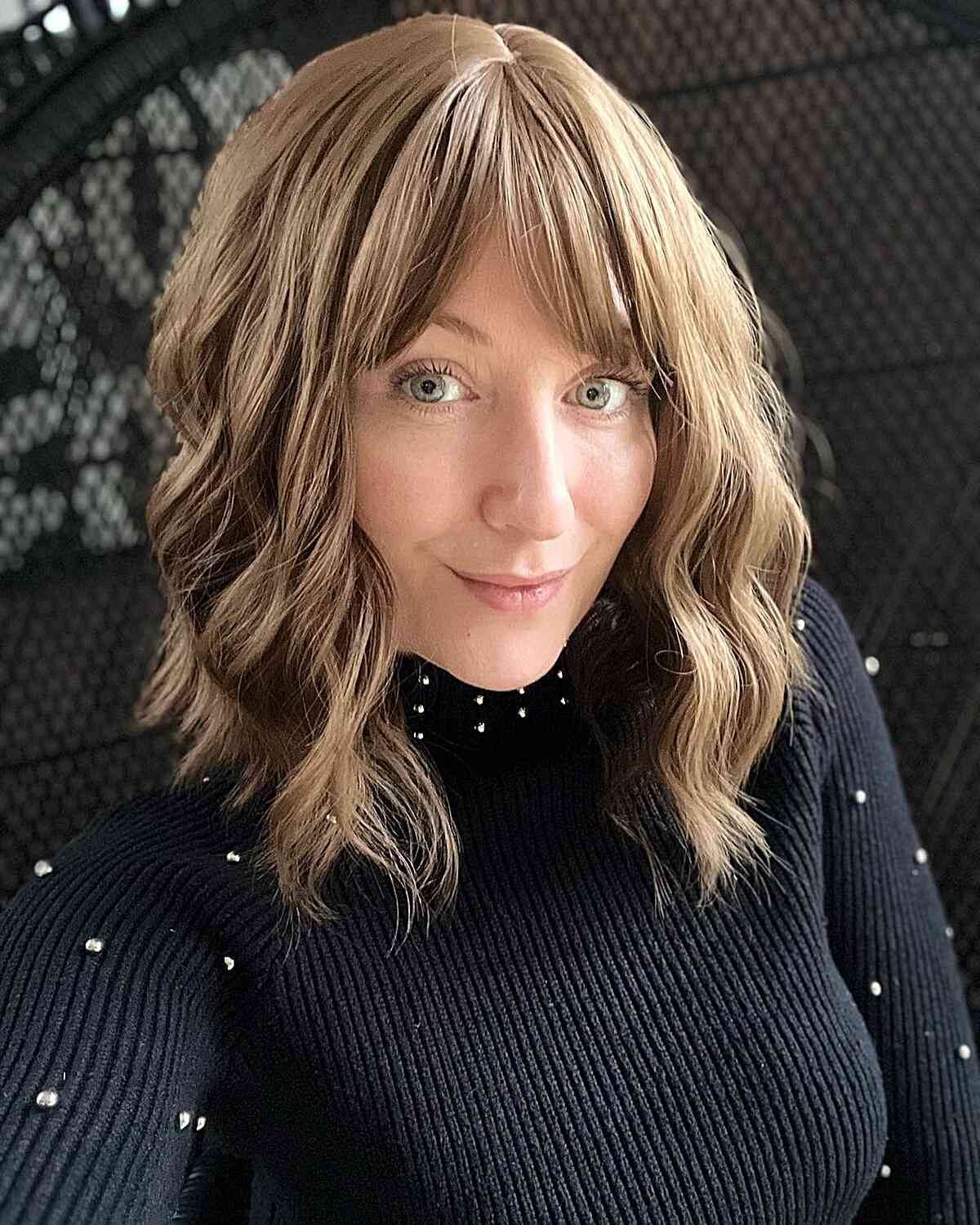 Medium hairstyle featuring angled bangs and flowing layers