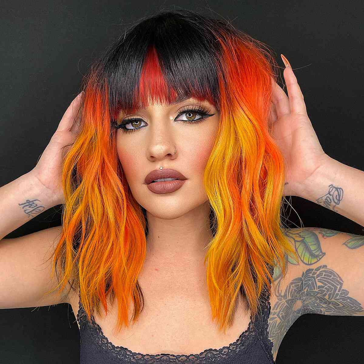 Vibrant Orange and Yellow Hair with Dark Bangs