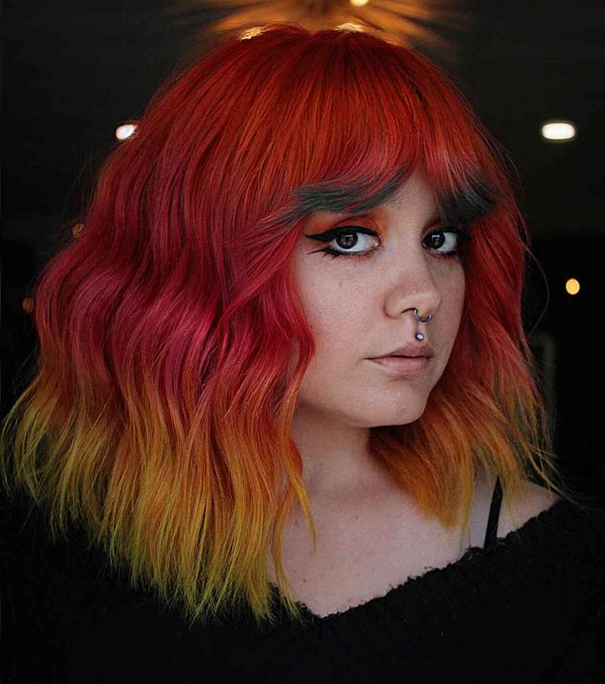 Vibrant Red to Yellow Highlights Hair Color Inspiration for women with round faces and a trendy vibe