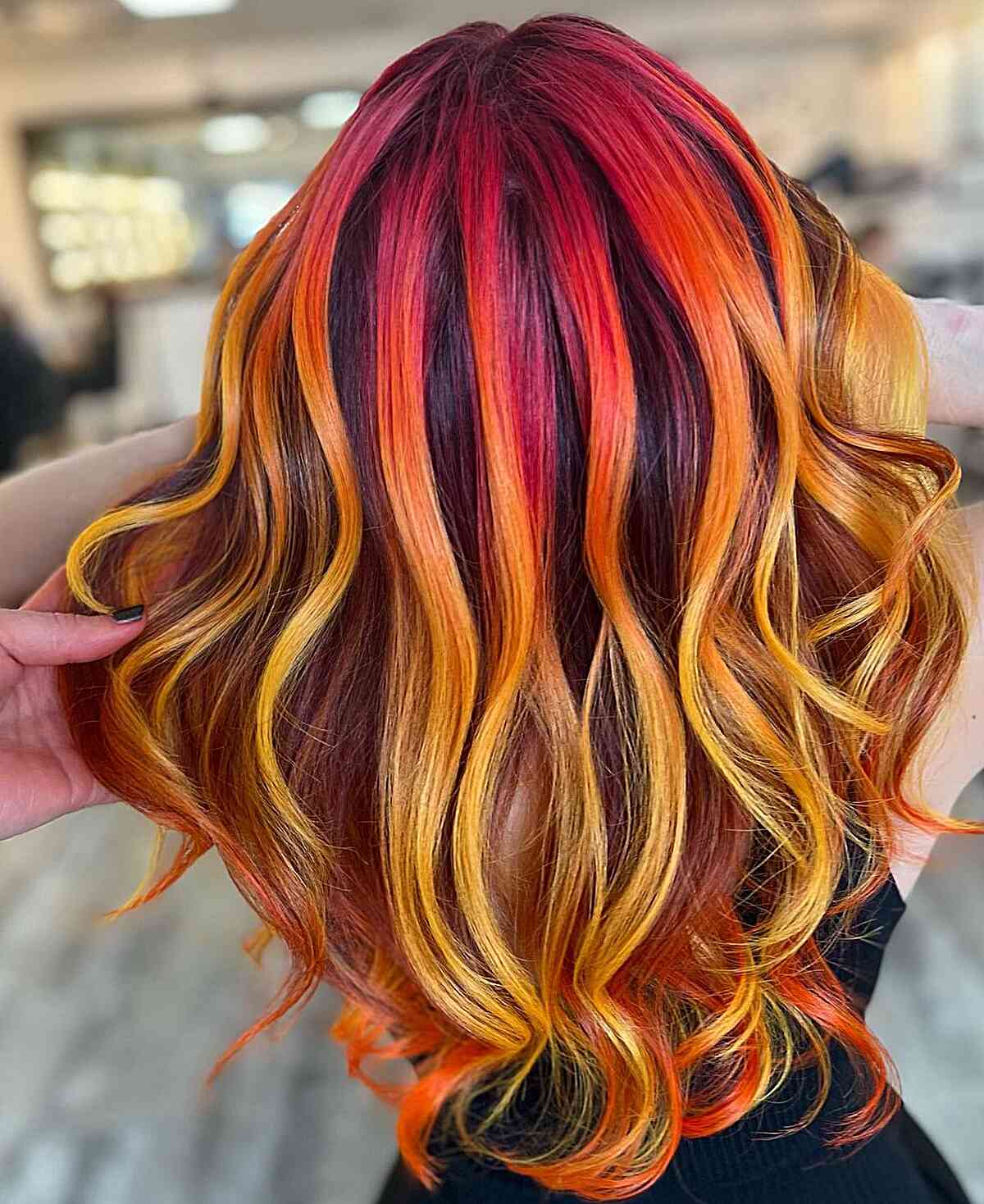 Vibrant Red, Yellow, and Orange Shades Hair Color Ideas for women with wavy hair