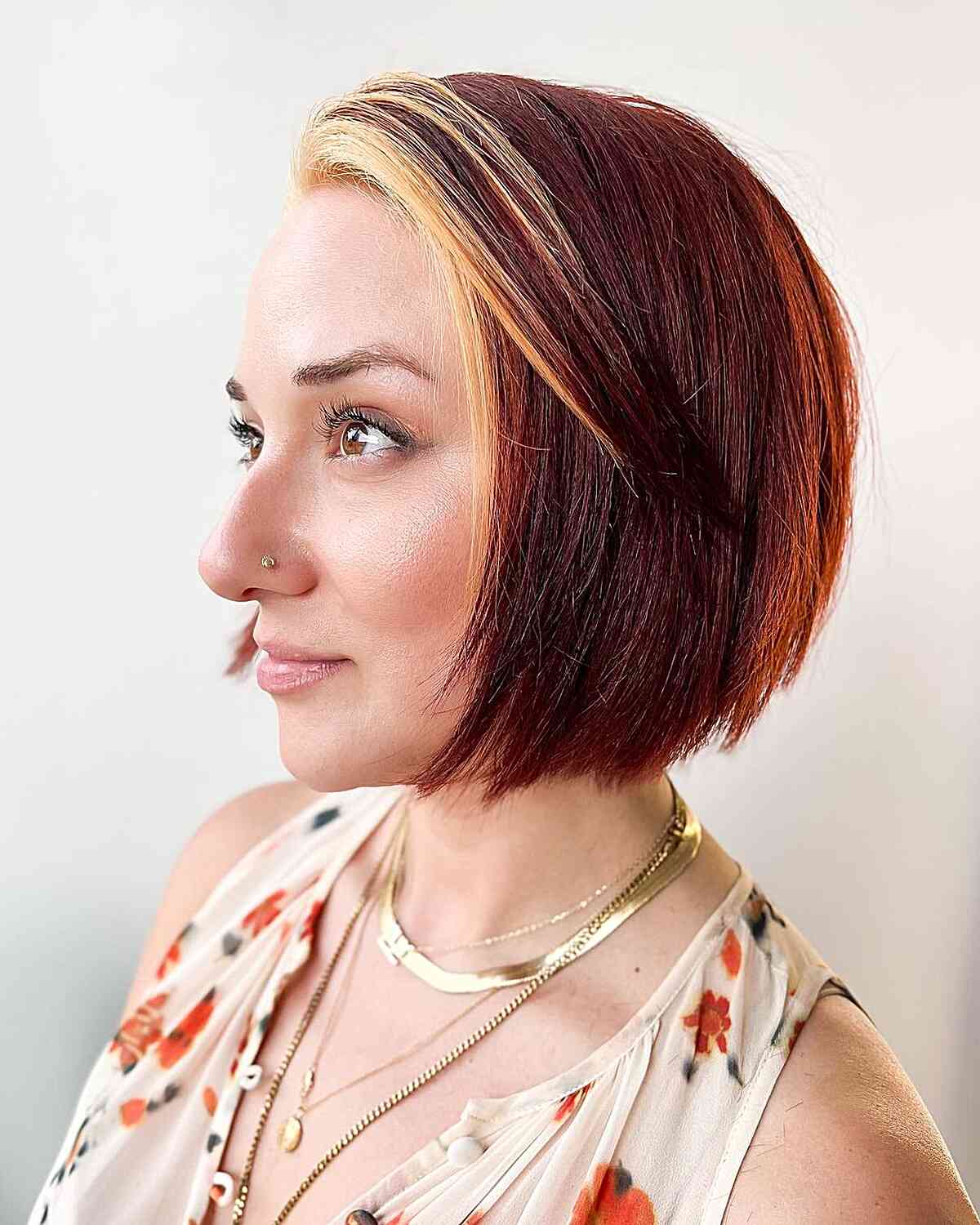 Vibrant Short Red Bob with Blonde Bangs