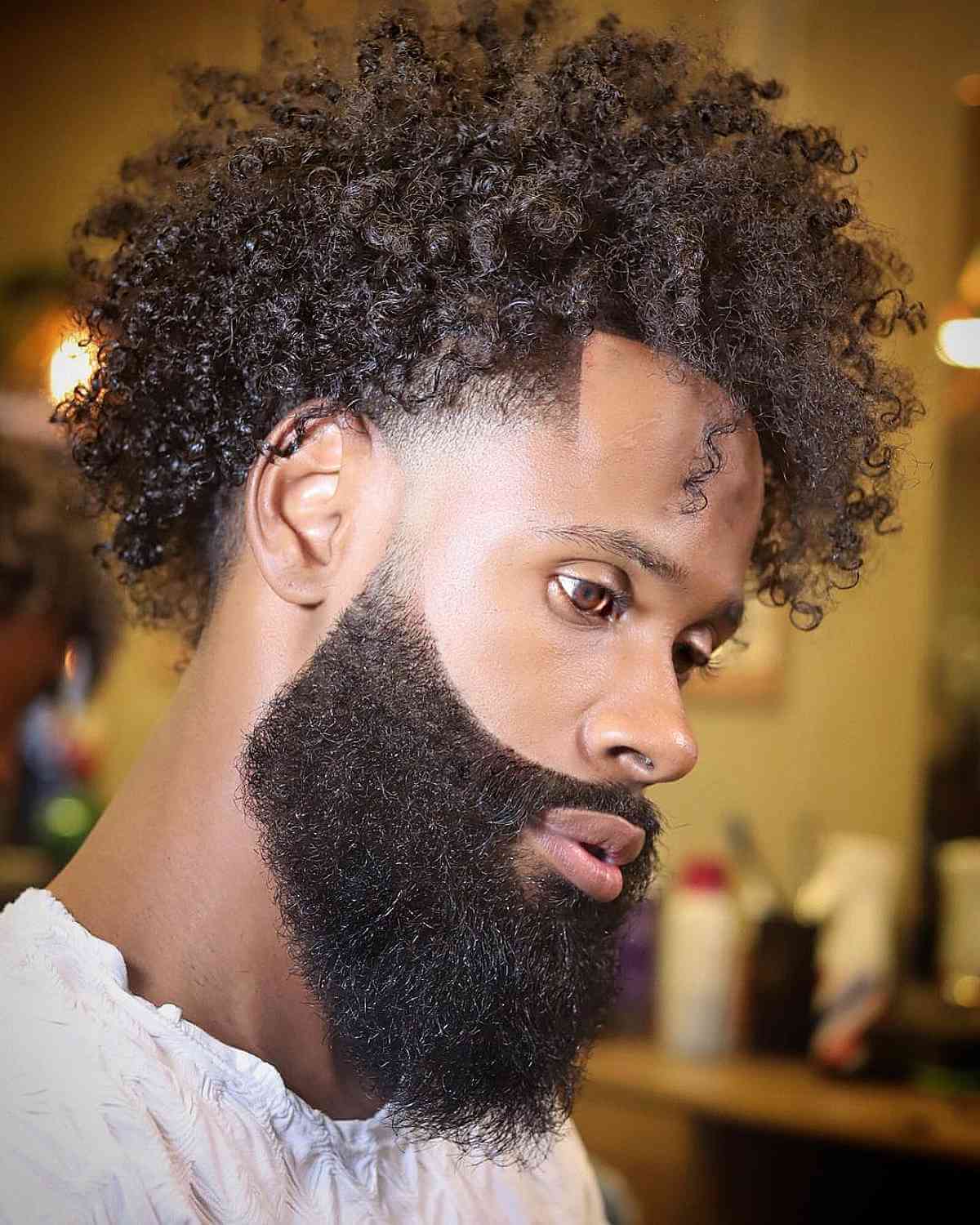 Voluminous Curls Paired with a Beard for Black Men