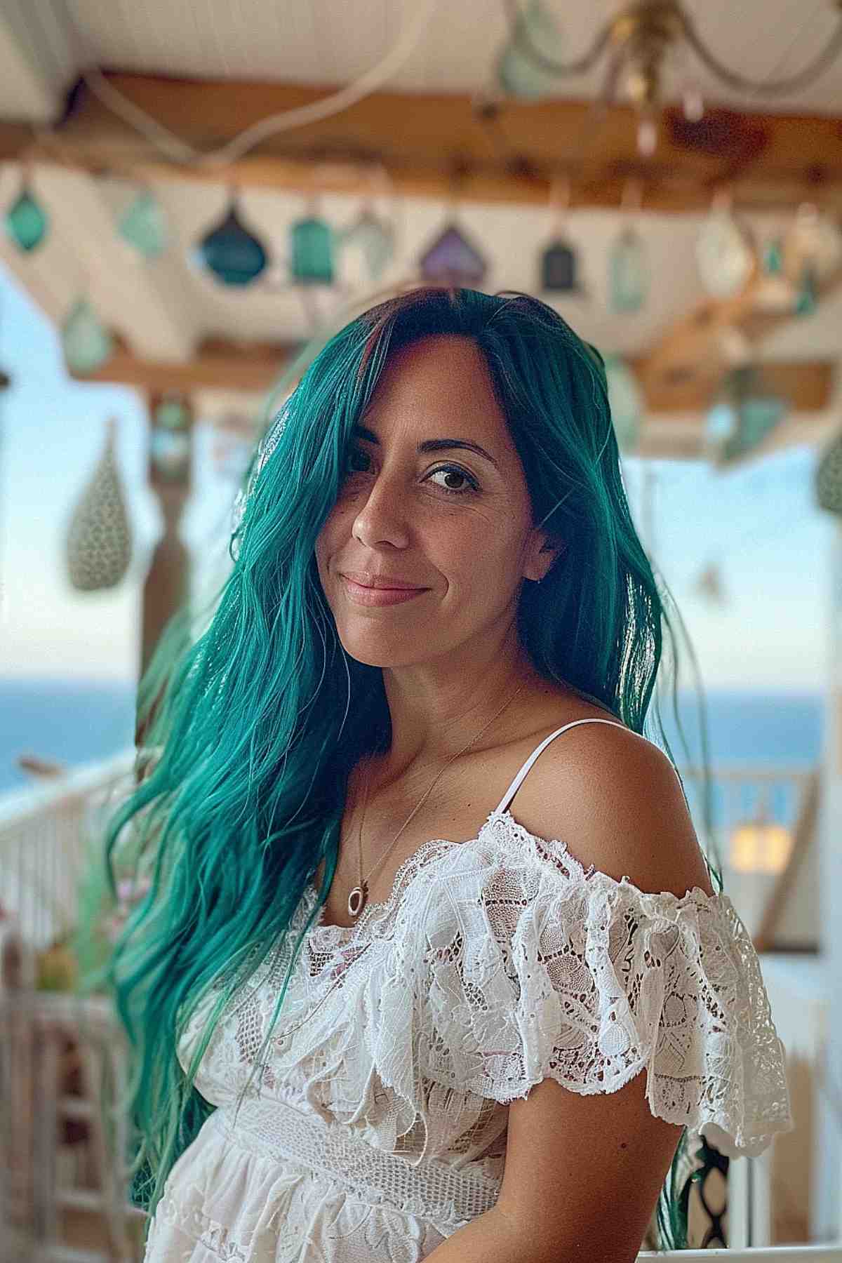 Waist-length hair featuring teal tones and soft beachy waves