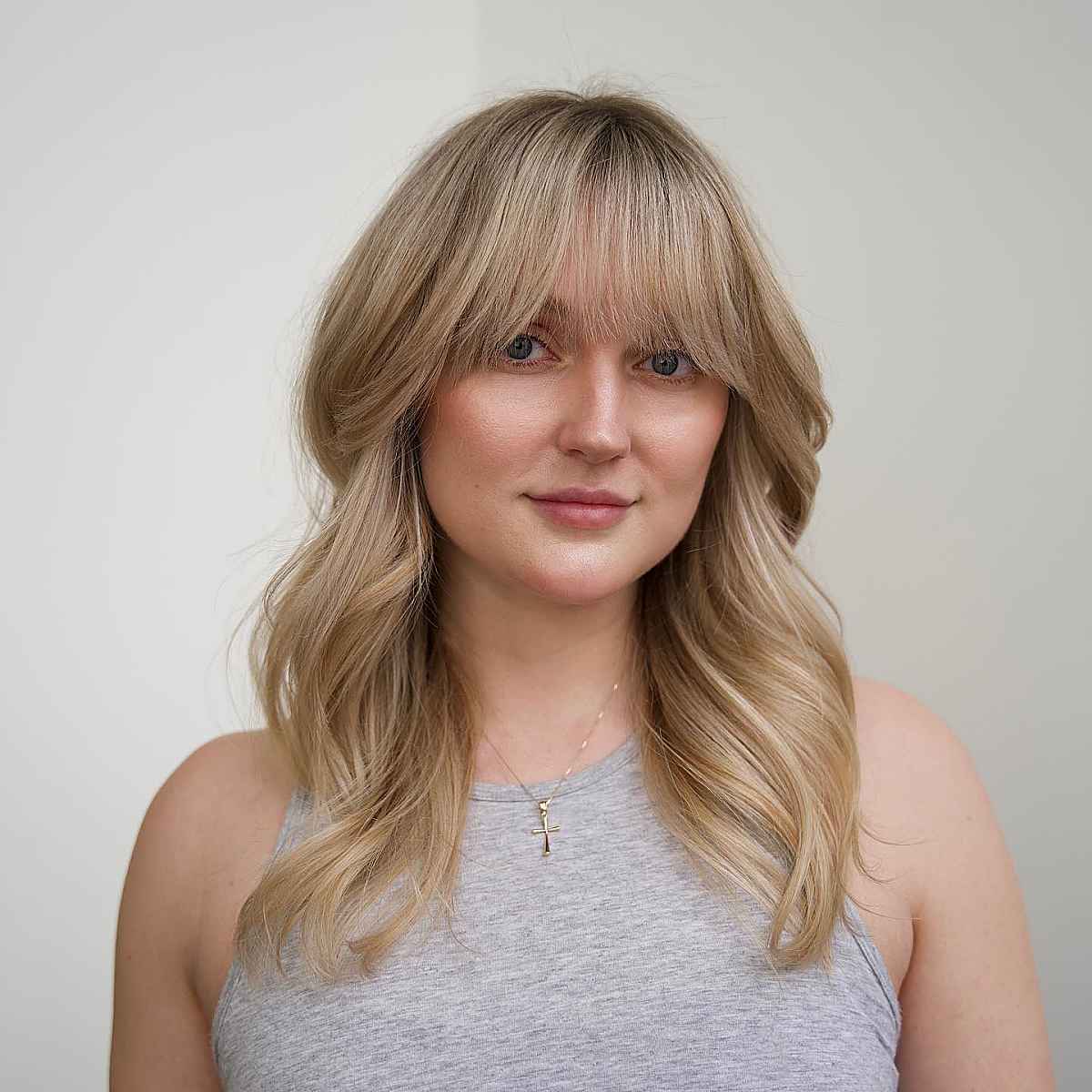 warm sandy blonde curls for medium-length hair