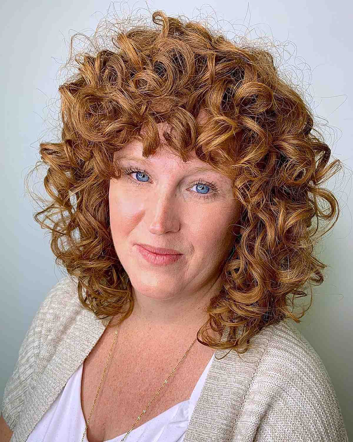 wavy natural redhead with bangs