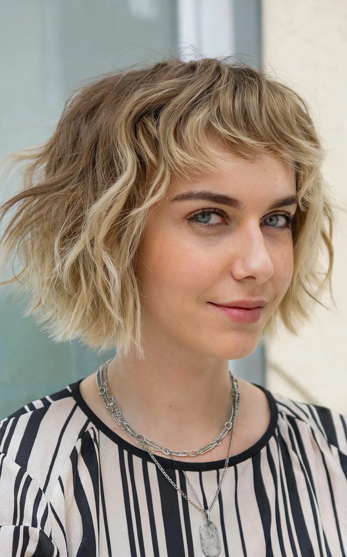 Wavy Short Layers Featuring Micro Bangs for Chin-Length Hair