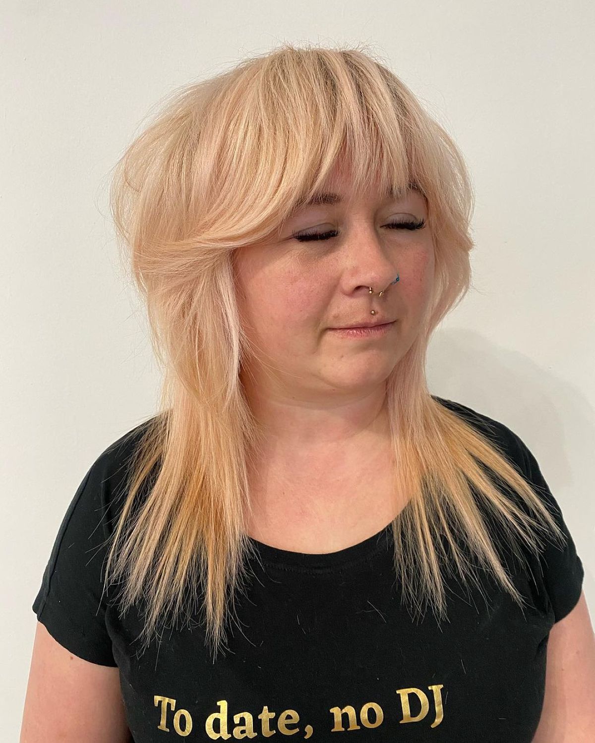 Wolf Hairstyle Featuring Bangs and Textured Layers