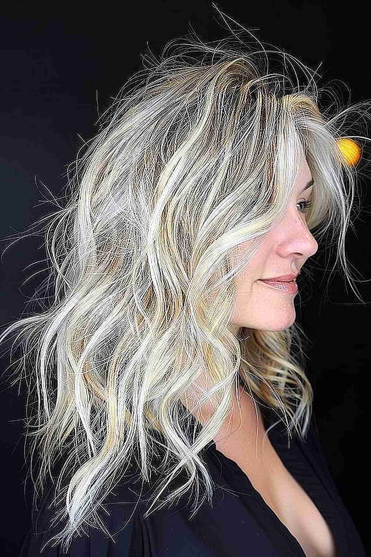 Long layered wavy hair with multi-dimensional silver and blonde tones