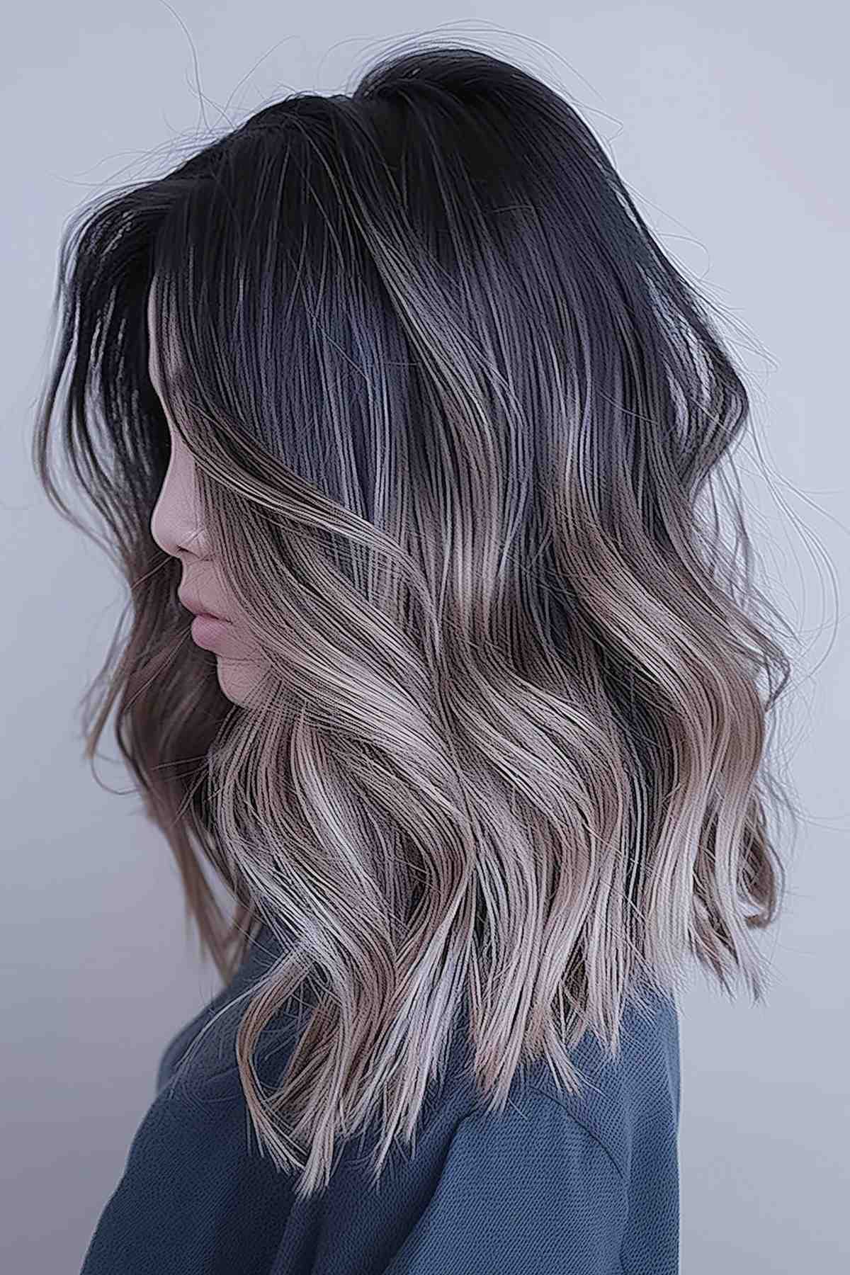 Medium-length mushroom brown hair with soft ombre transition to lighter tips, styled into loose waves.