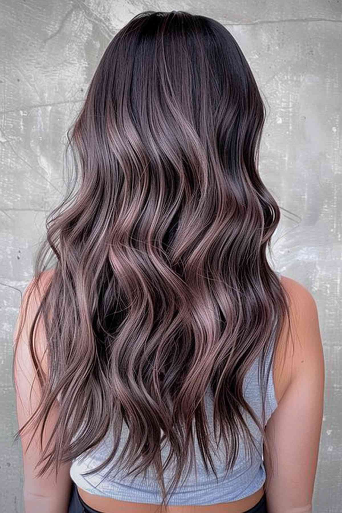 Long, wavy hair in mushroom brown with subtle violet undertones, enhancing depth and adding a unique twist to the natural brown shade.