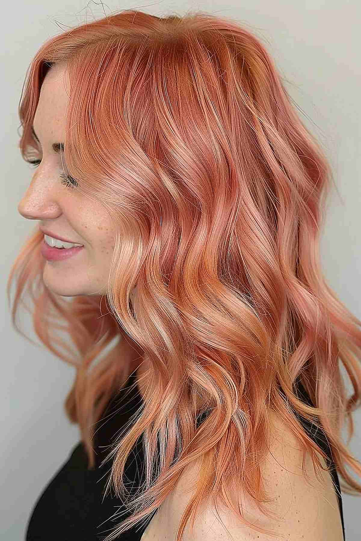 Soft waves in muted peach layers, blending naturally to enhance volume and texture, ideal for lighter skin tones seeking a warm, inviting look.