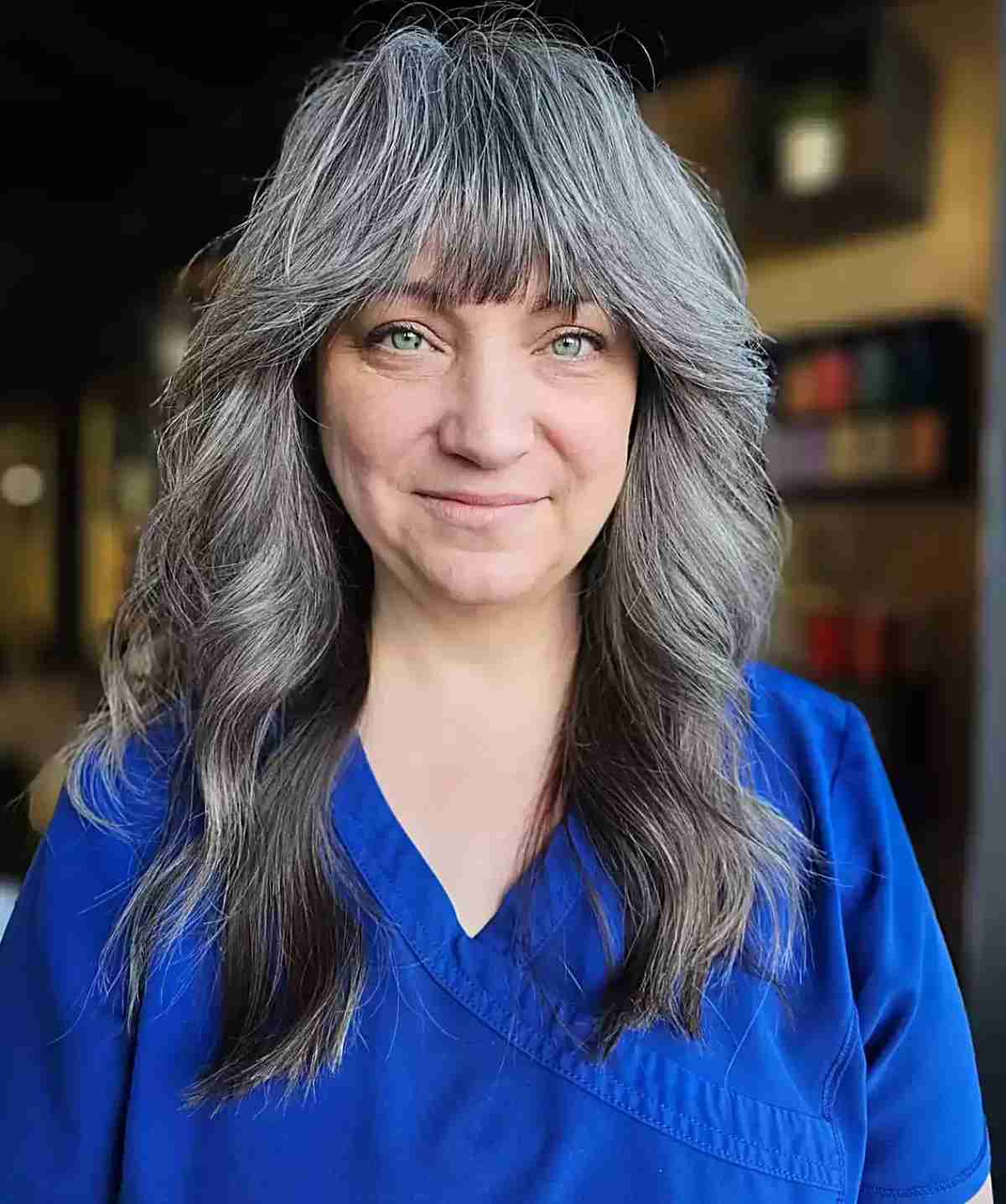 Natural Grey Balayage on Medium Wavy Hair with Bangs for Older Women