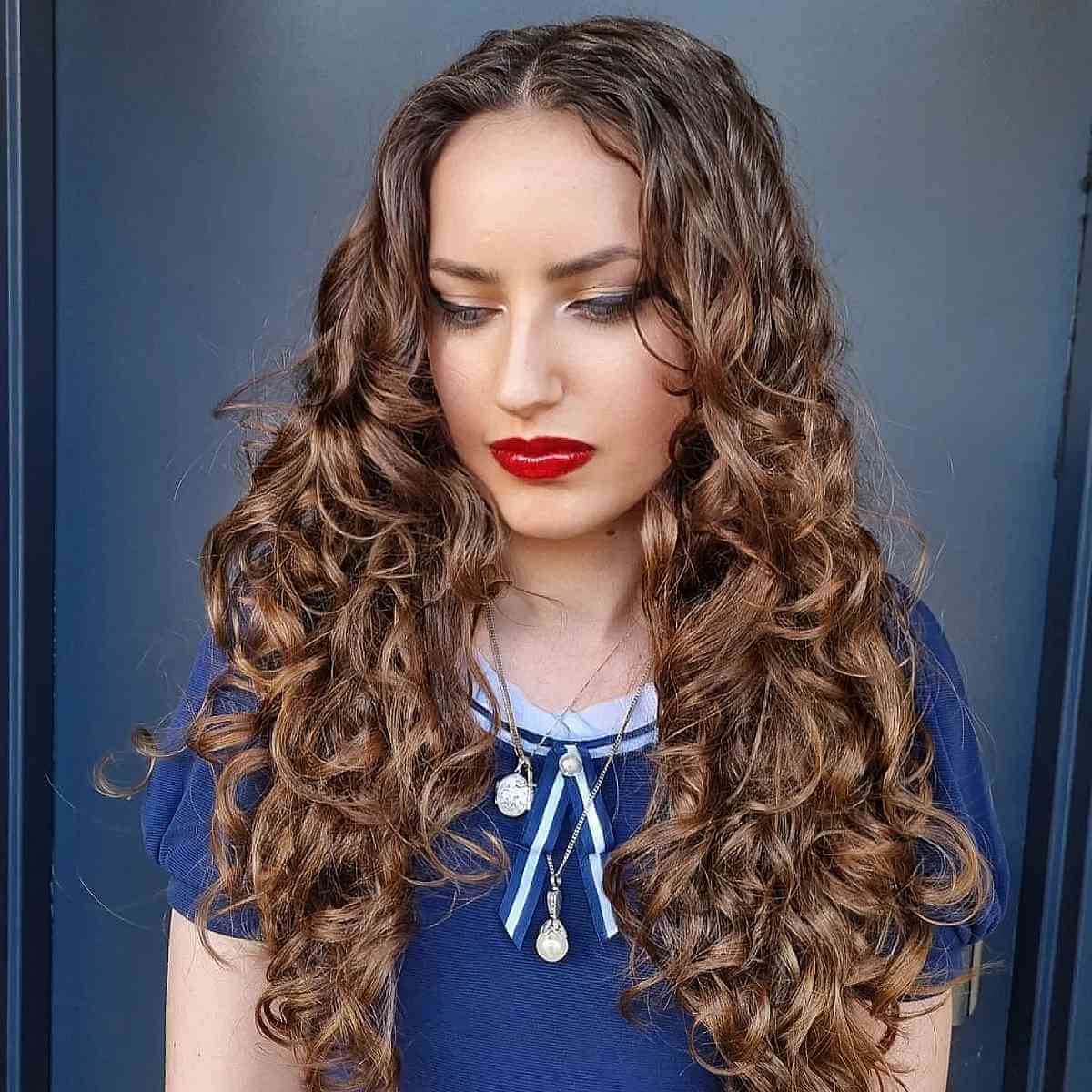 Naturally curly hair with center part for long face shapes