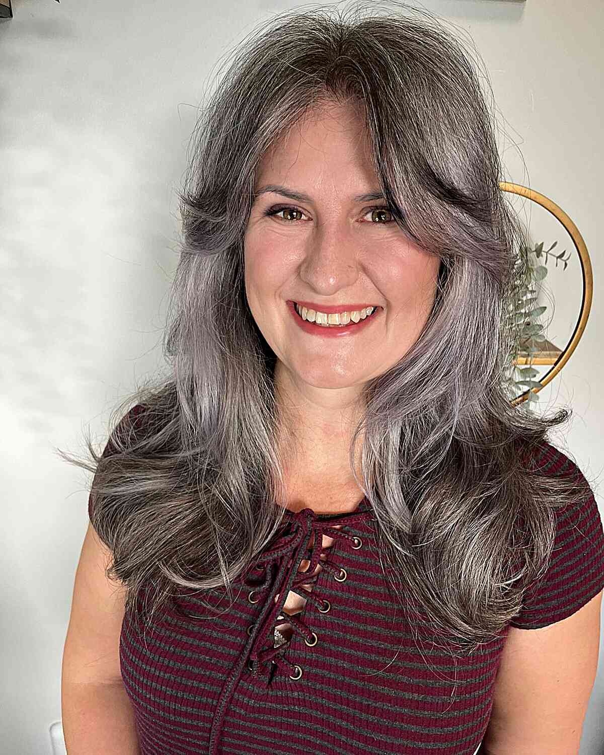 Naturally Salt-and-Pepper Medium Haircut with layers and Long Curtain bangs for ladies over 40