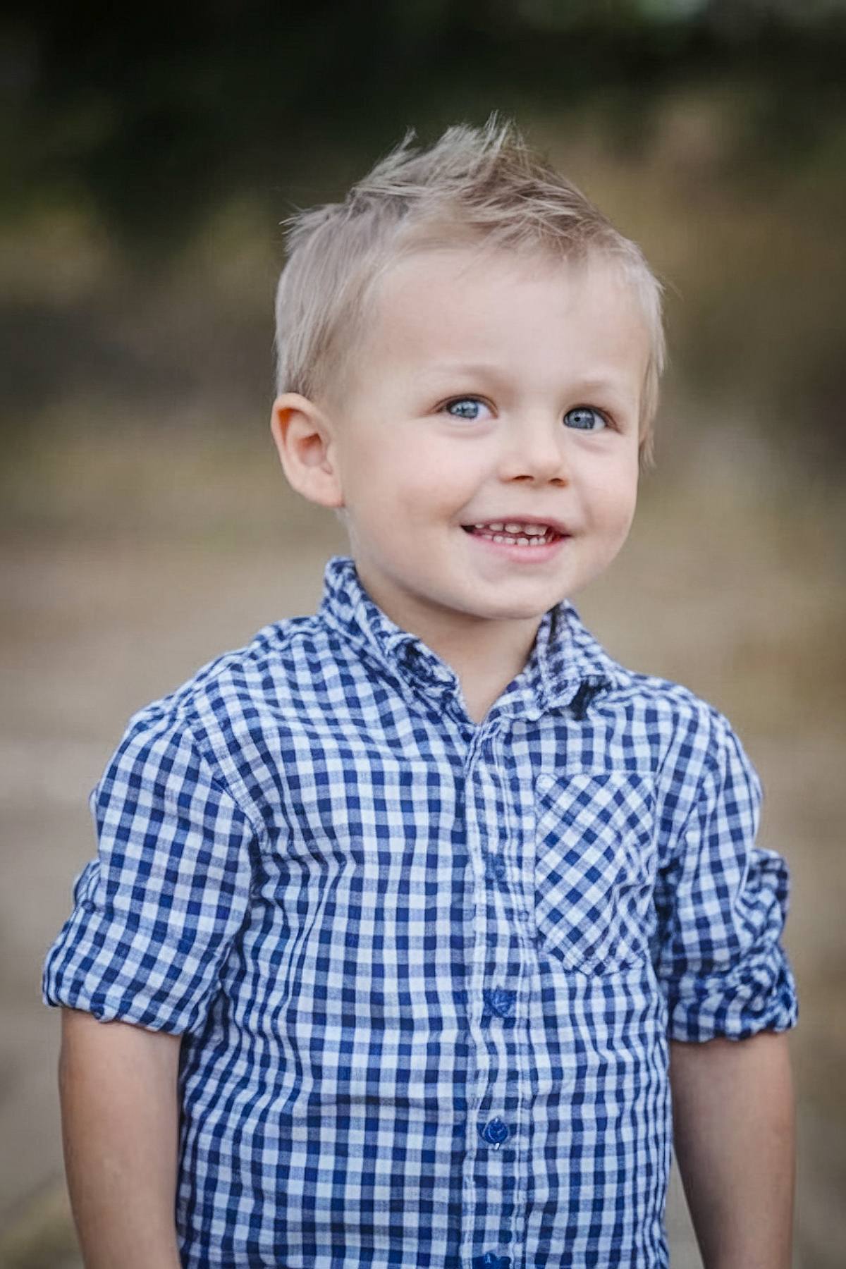 Preppy toddler boy hairstyle with combed back top