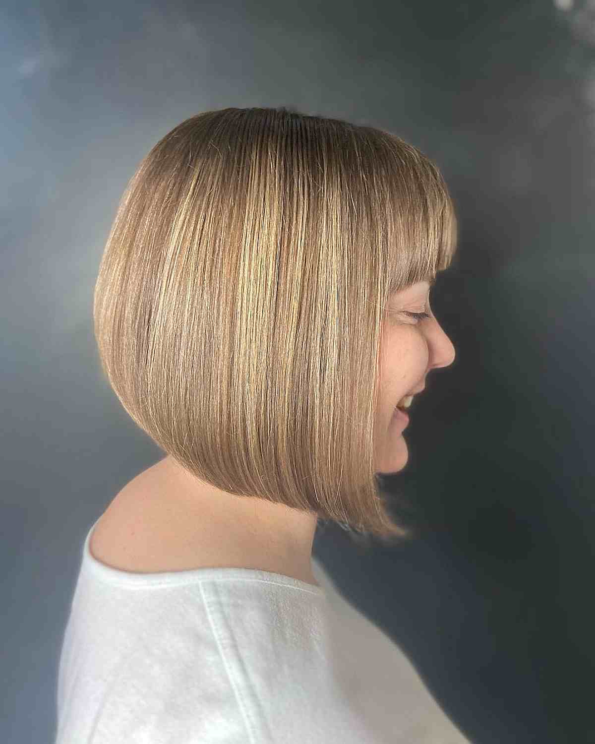 Neck-Grazing A-Line Bob Cut with Blonde Highlights and Bangs