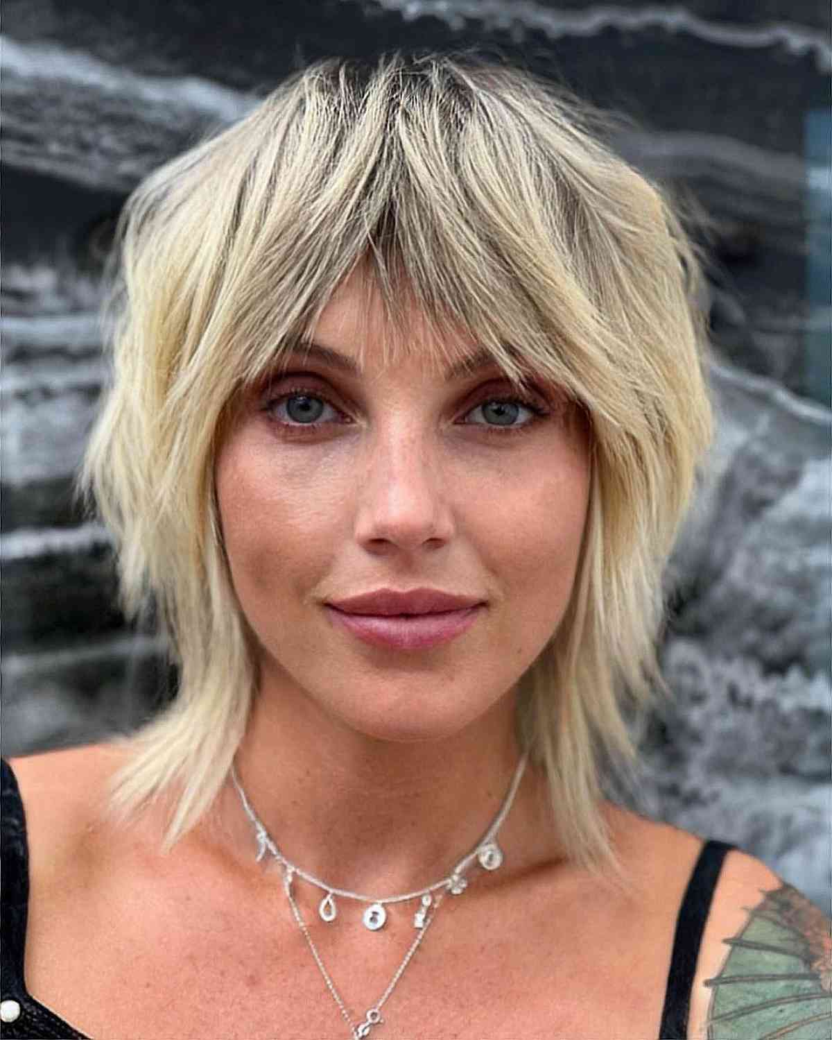 Neck-Length Blonde Shag with Dark Roots and Bangs