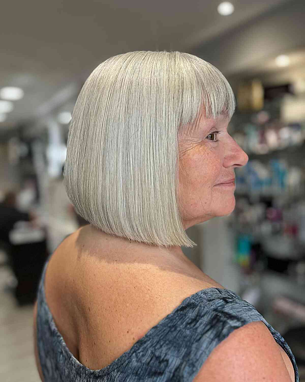 Neck-Length Bob Haircut with Full Bangs on Seniors Aged 50
