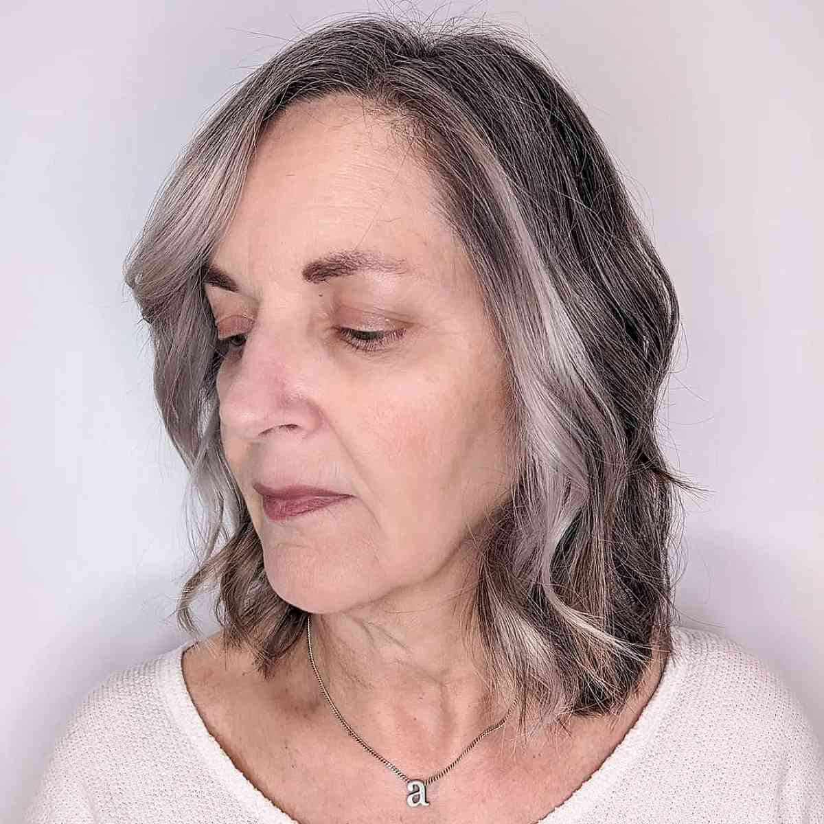 Neck-Length Layered Hair with Waves for a 60-Year-Old Lady