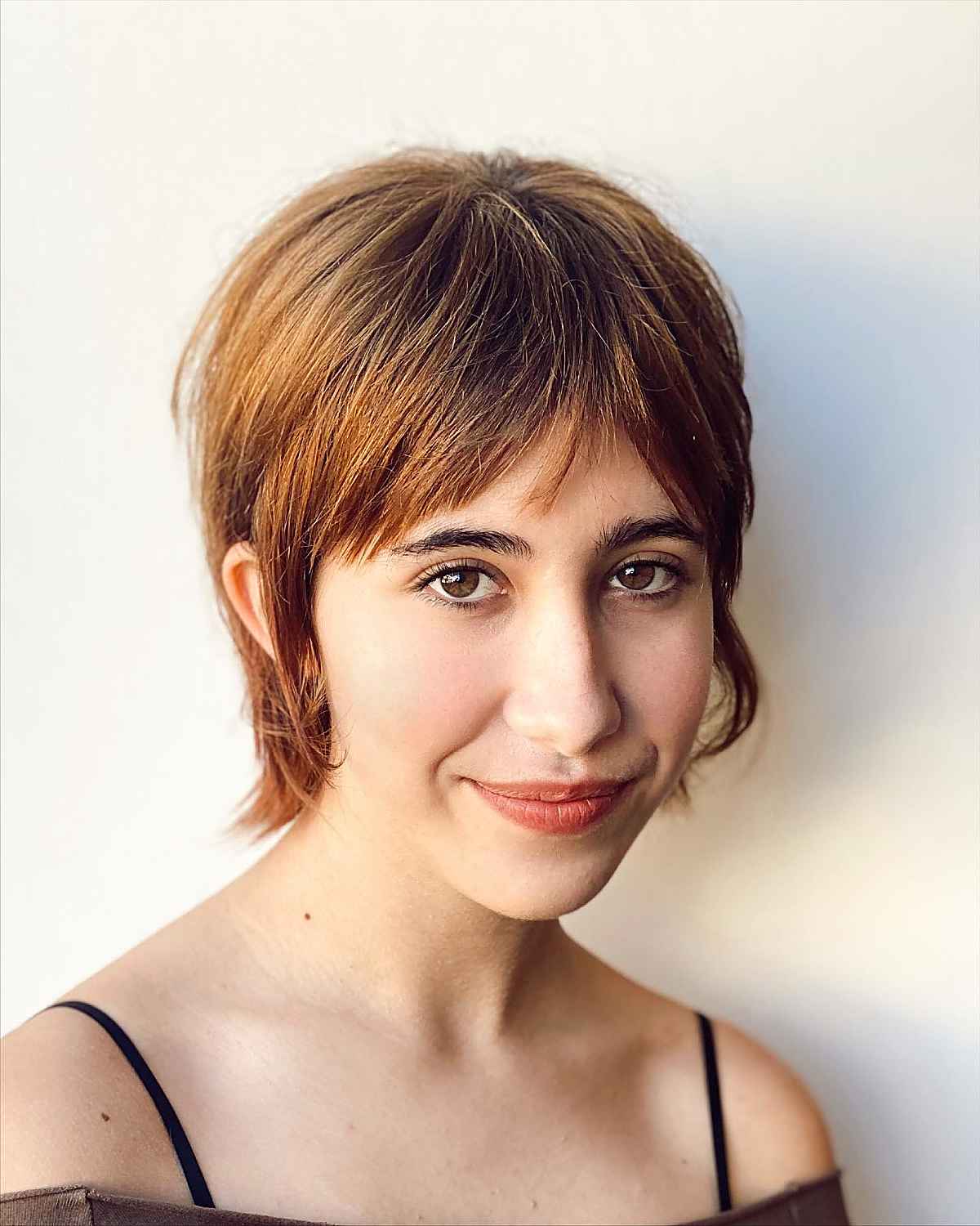neck-length pixie mullet with curtain bangs
