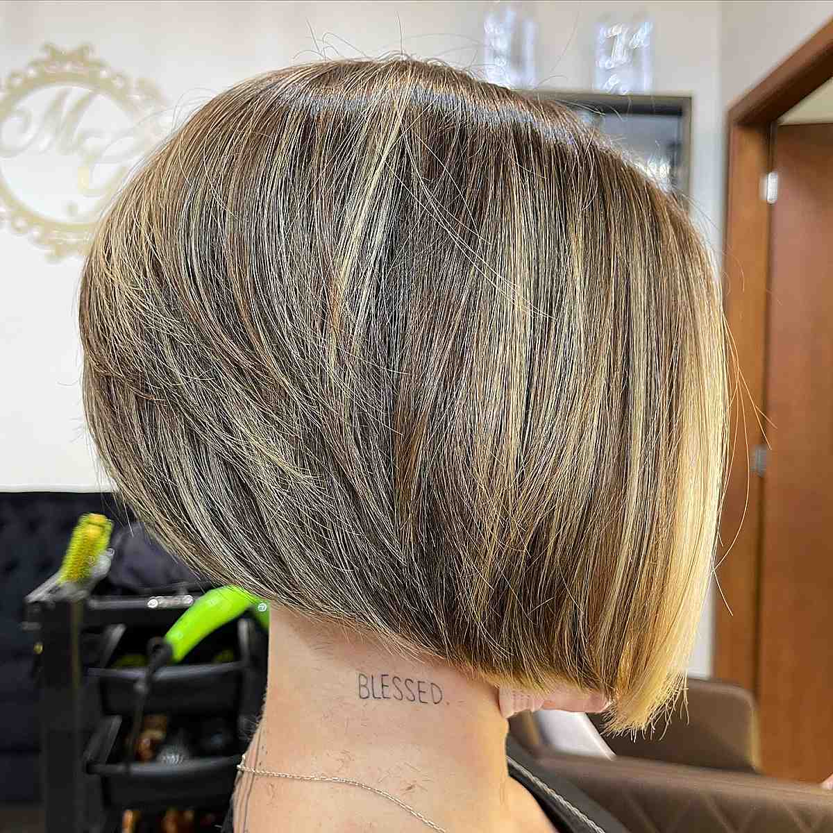 nicely stacked angled bob with blonde highlights