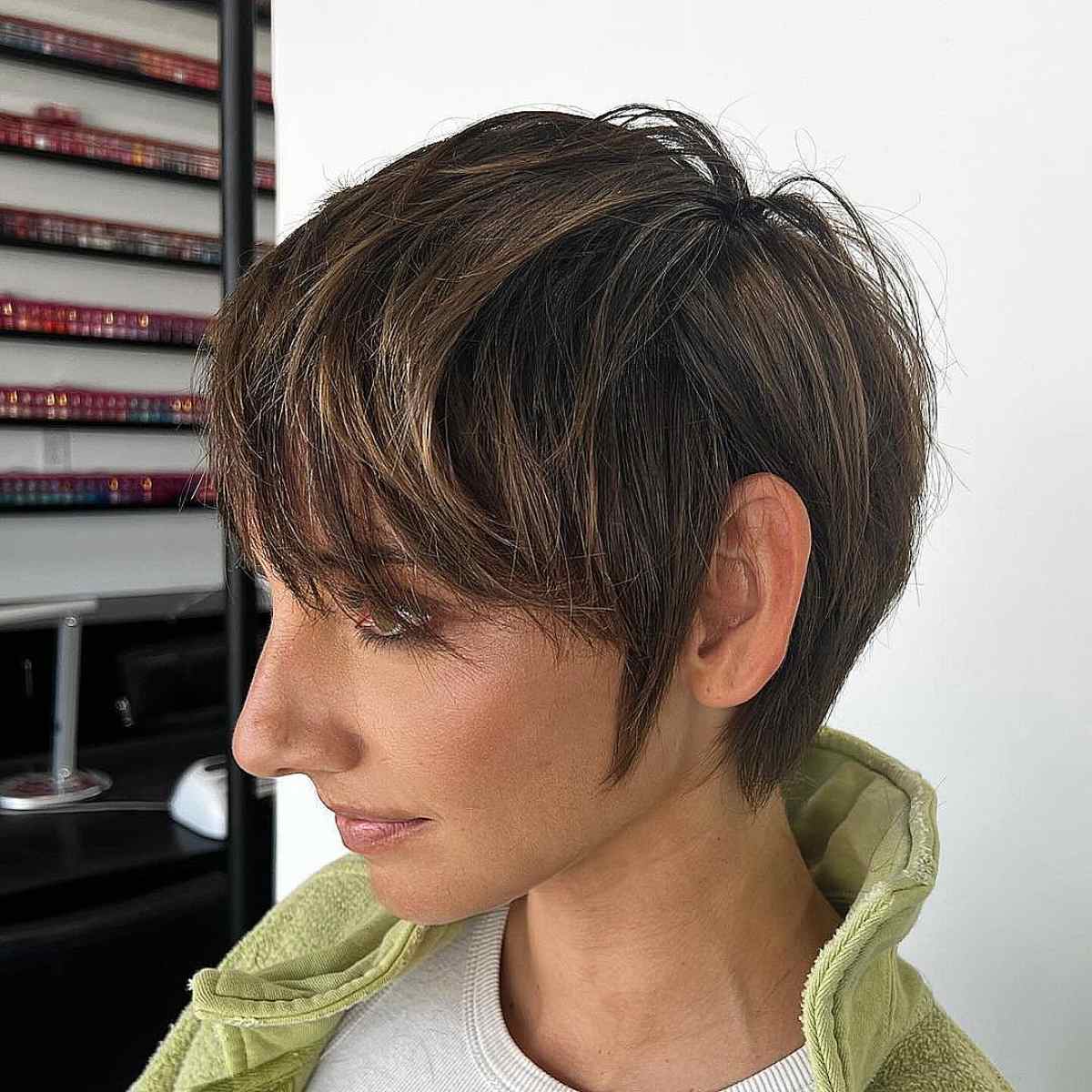 Layered pixie cut with subtle highlights and textured layers on fine to medium hair