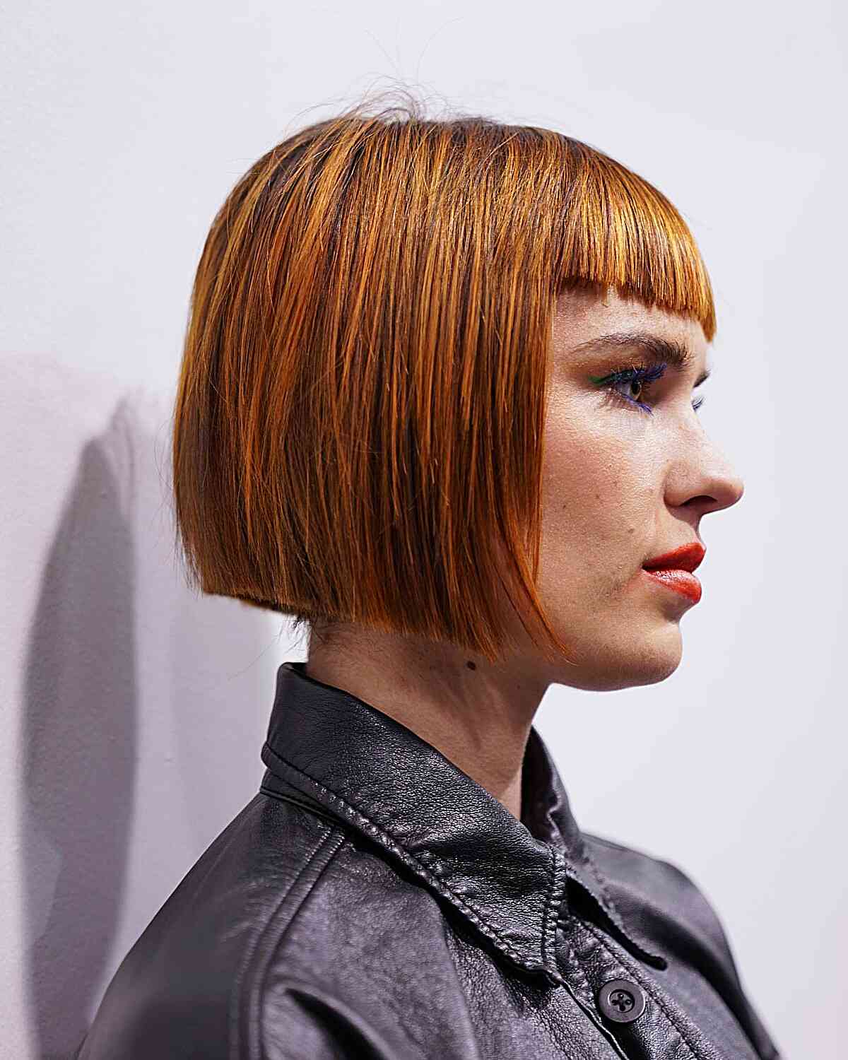 One-Length Precision Bob Cut with Orange-Yellow Highlights