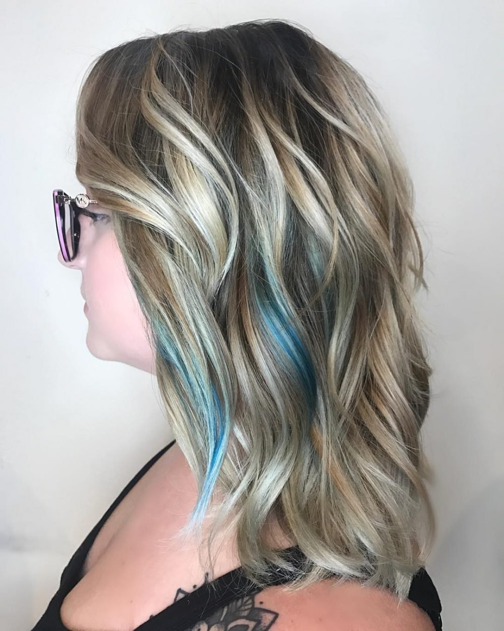 Layered Hair with Blonde Highlights and Blue Peekaboo Highlights
