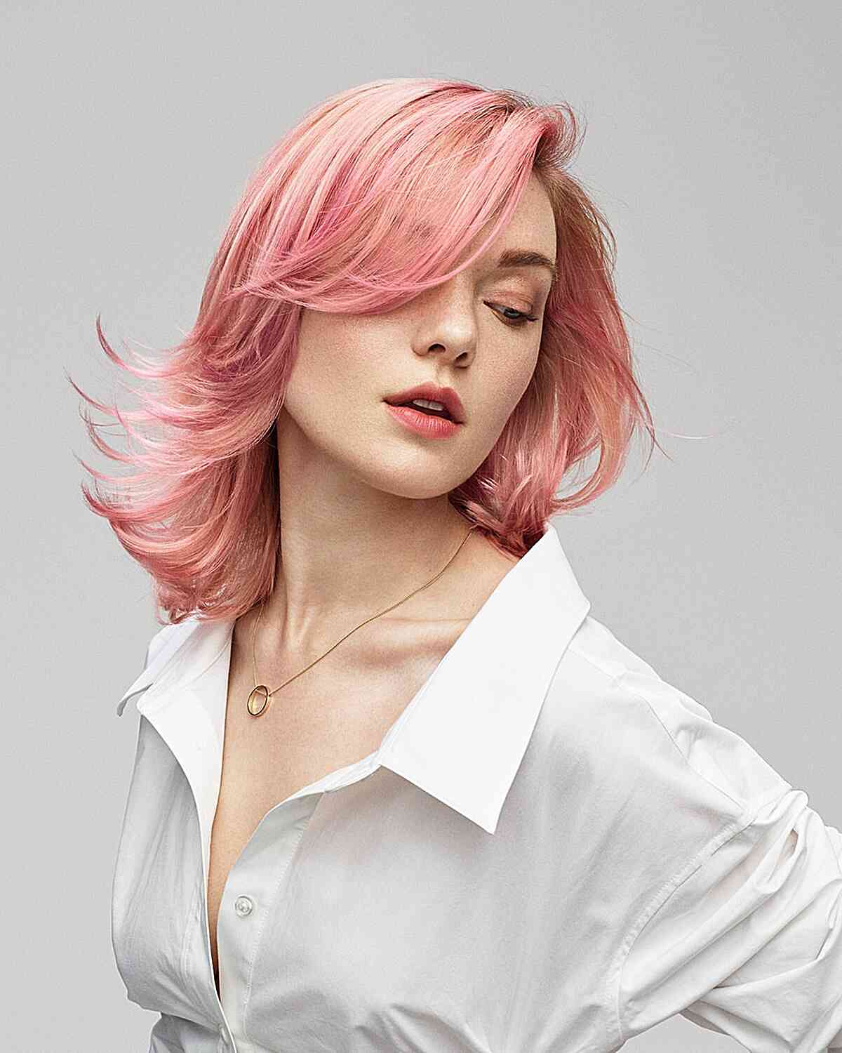 Pink Layered Cut with Side Bangs and Feathered Ends for Shoulder-Length Hair
