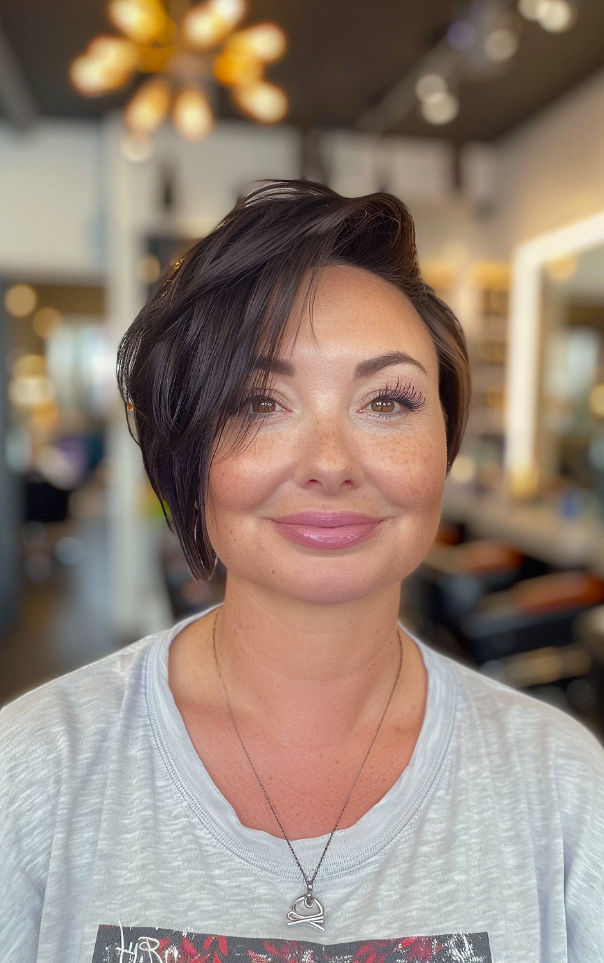 Asymmetrical pixie bob hairstyle for chubby faces with layered texture