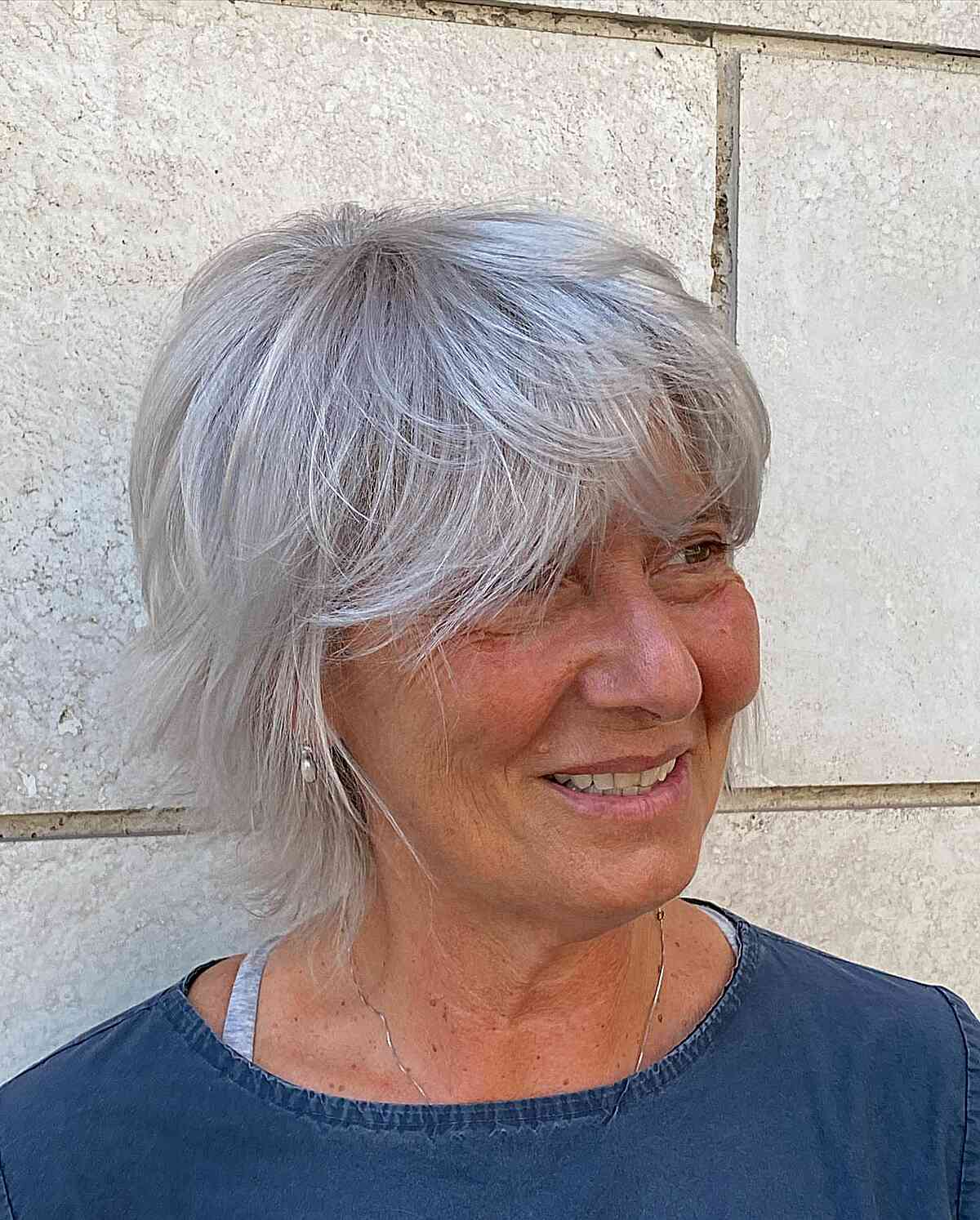 Jaw-Length Pixie Bob with Wispy Layers and Bangs on Ladies Over Sixty with Grey Hair