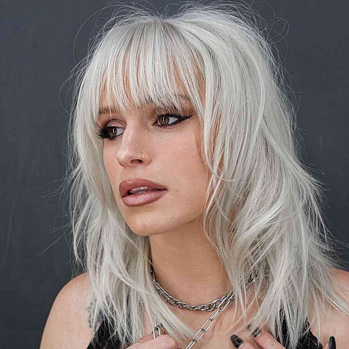 Platinum Hair Color on a Shoulder-Length Shag with See-through Bangs and wispy ends