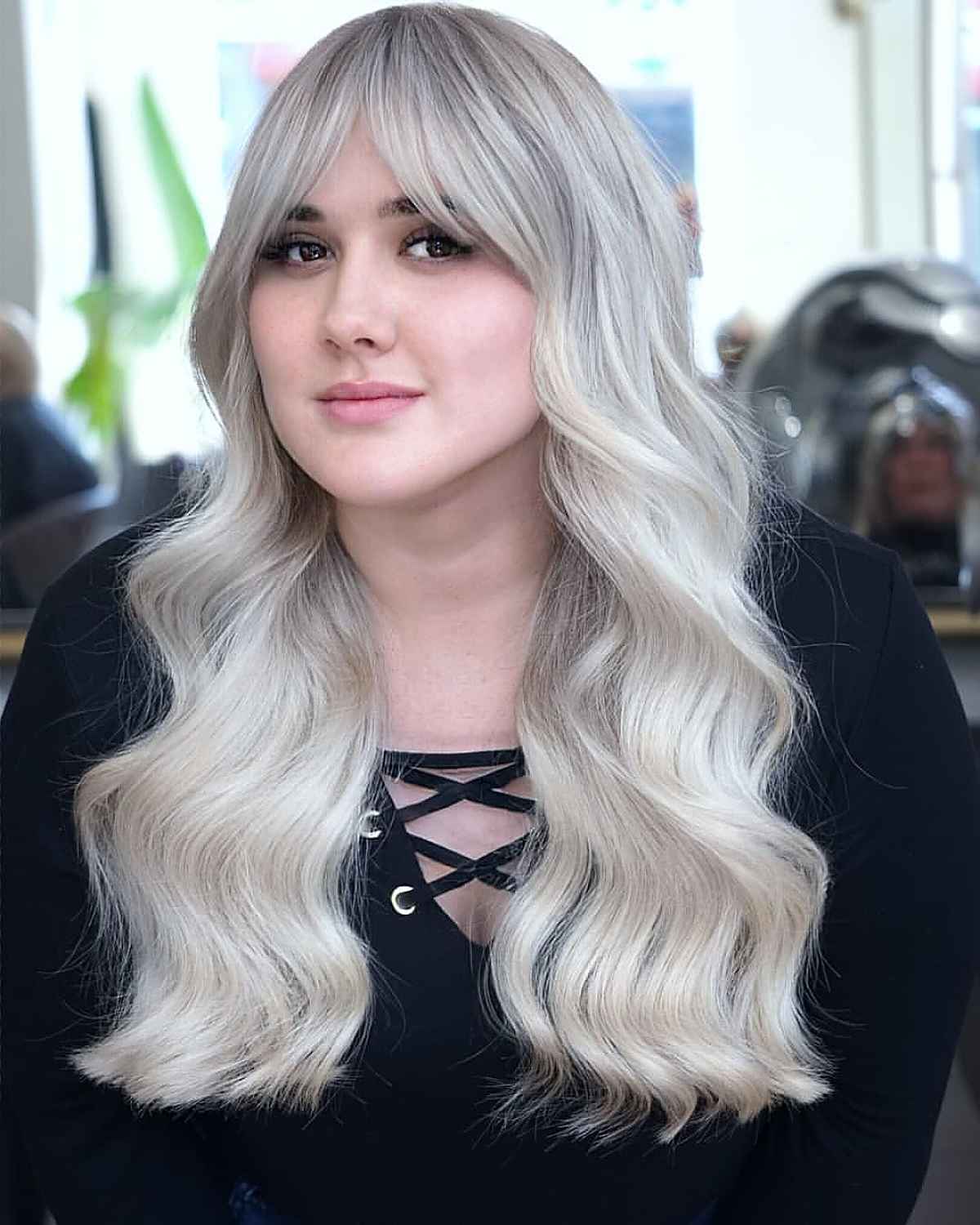 Platinum Wavy Hair with Curtain Bangs for a Fuller Face Shape