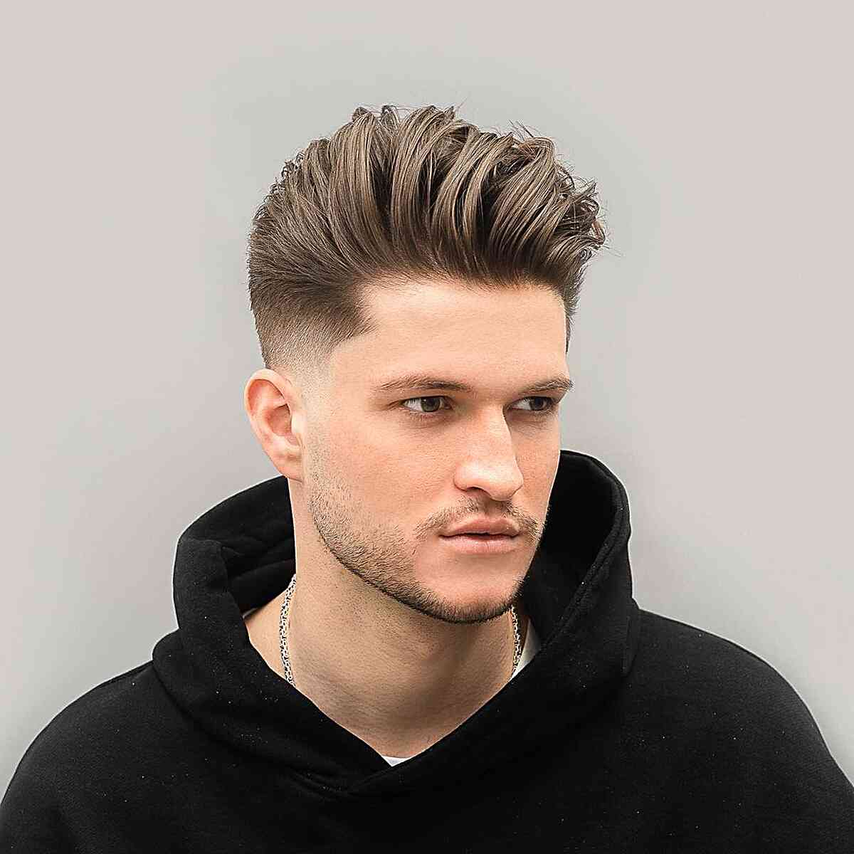 Free Photo | Portrait of a handsome young man posing in the studio with  modern straight hairstyle
