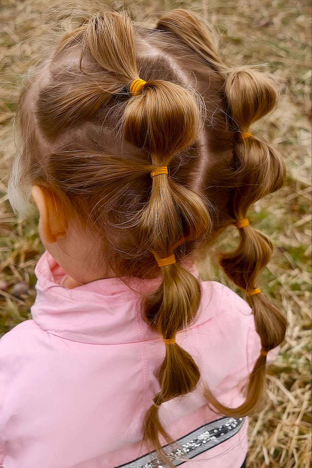 Half-up toddler hairstyle with roses for long hair