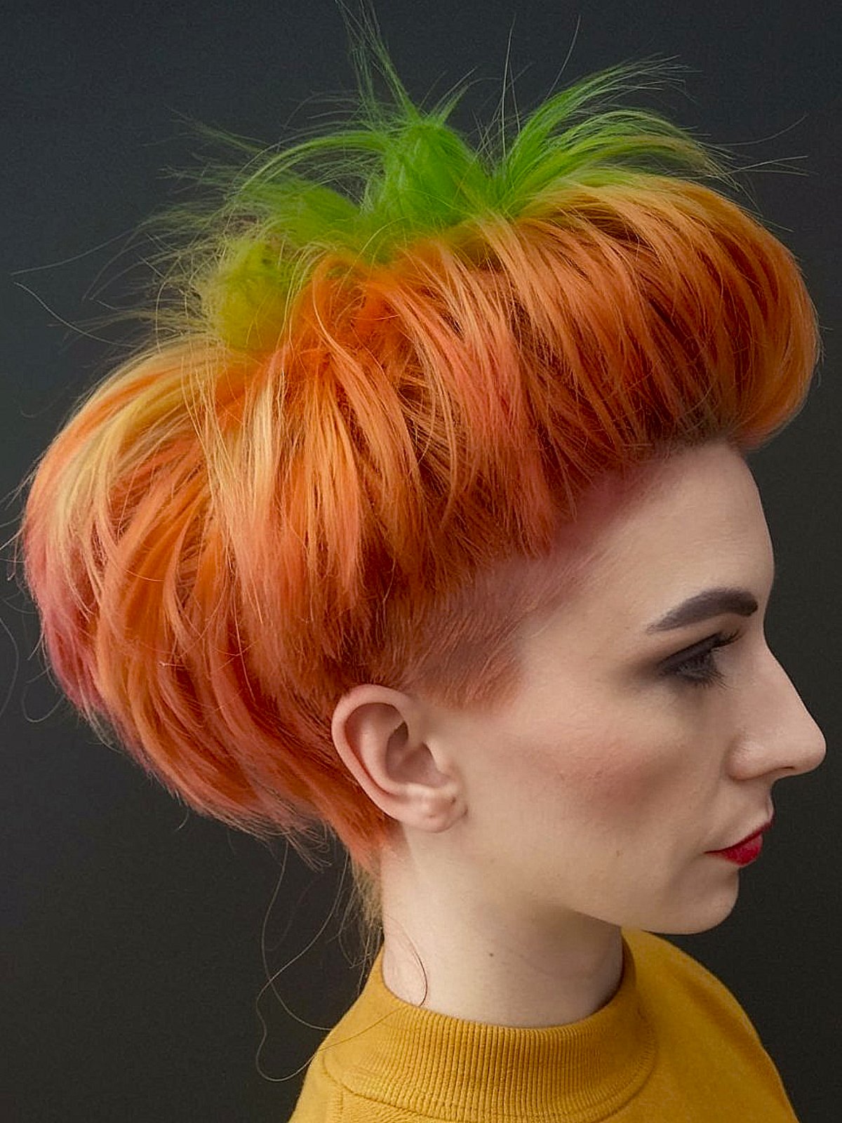 Pumpkin-inspired Halloween hairstyle with orange and green colors