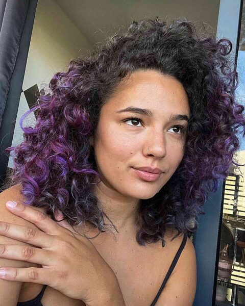 A Purple Ombre Highlights on Shoulder-Length Black Curls