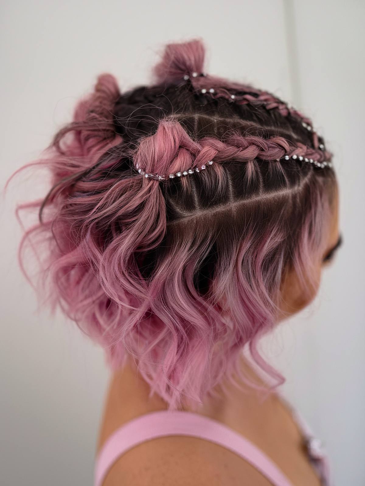 Short pink braids with curls for a rave hairstyle