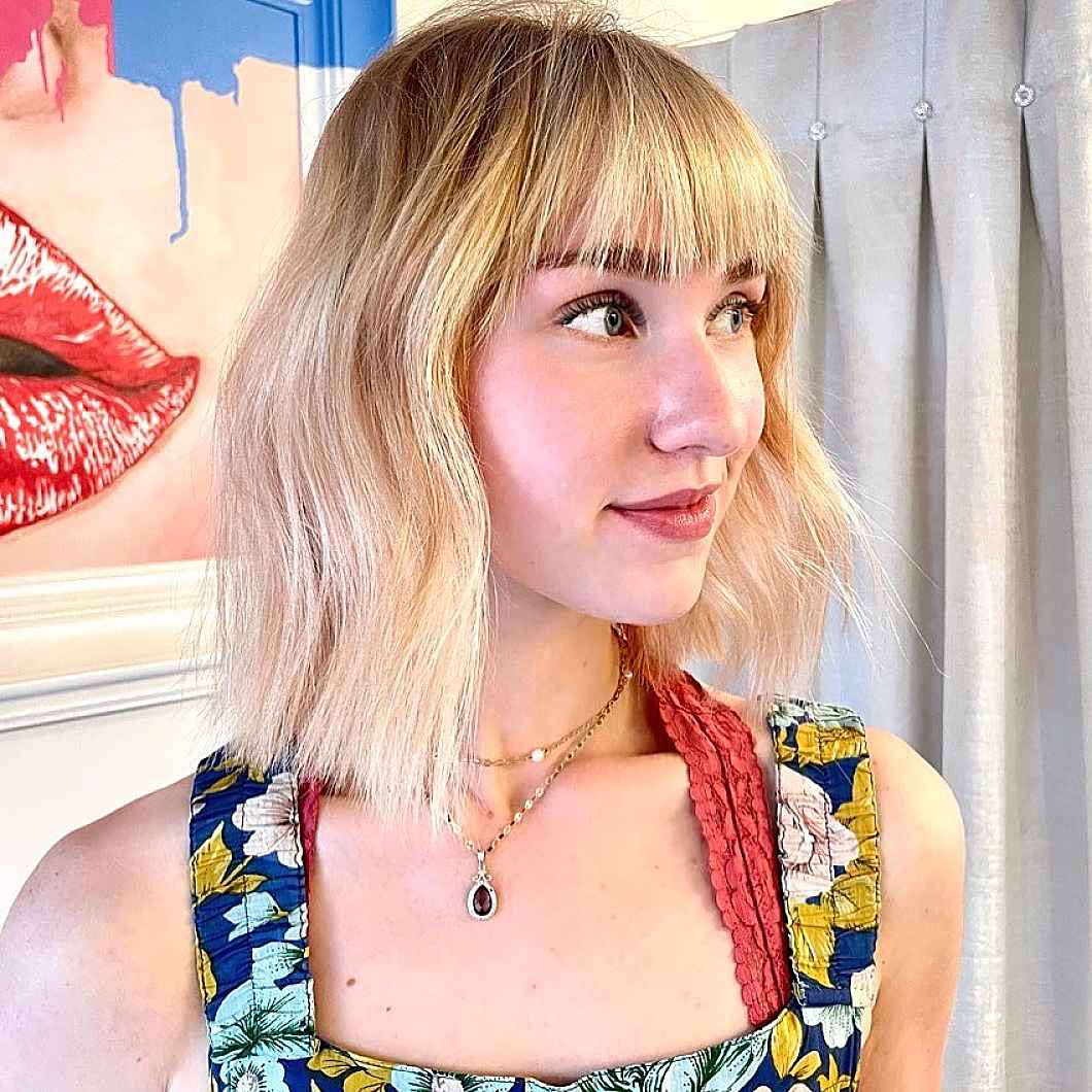 Lived-in razor cut short blonde bob with bangs