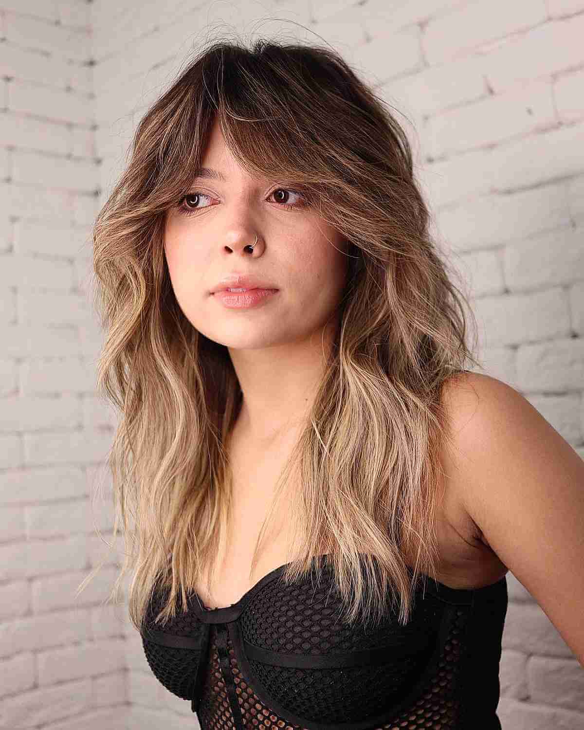 Modern Razored Cut Mid-Length Hair with Curtain Bangs for Round Faces