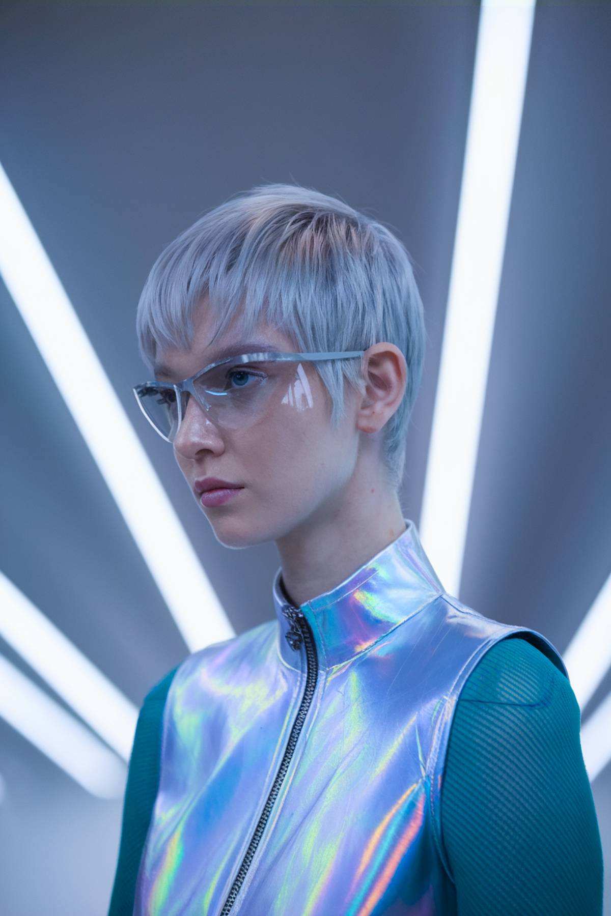 Futuristic razorveil pixie with sleek, fine layers and an icy silver tone for a high-fashion look