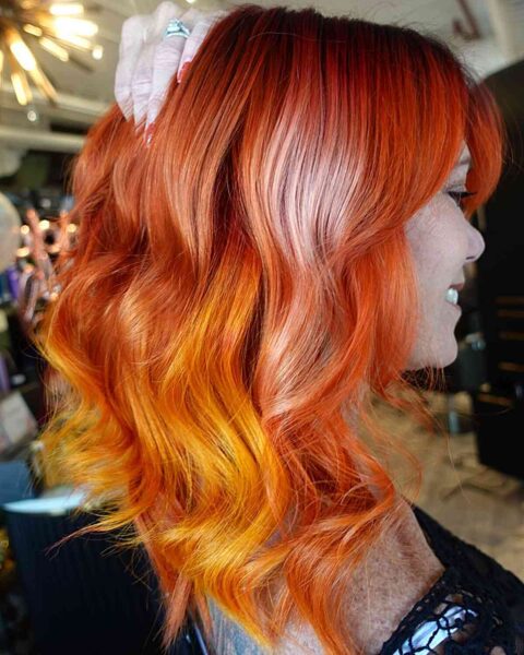 A Red Balayage with Sunset-Inspired Tones
