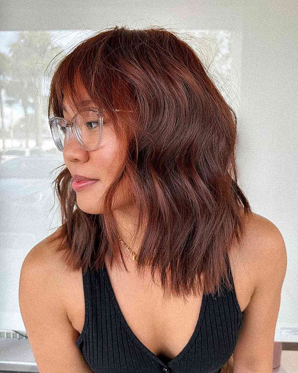 Red Mid-Length Wavy Hair with Choppy Ends and Wispy Bangs