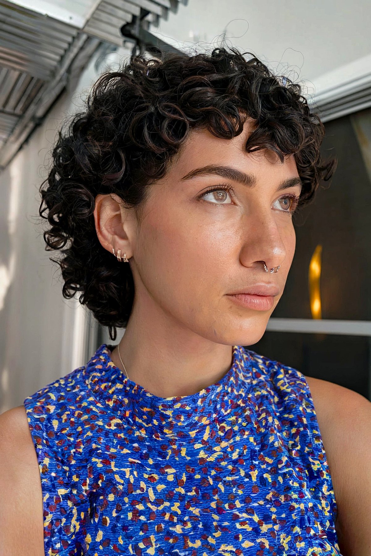 Tight curly mullet haircut with defined natural curls