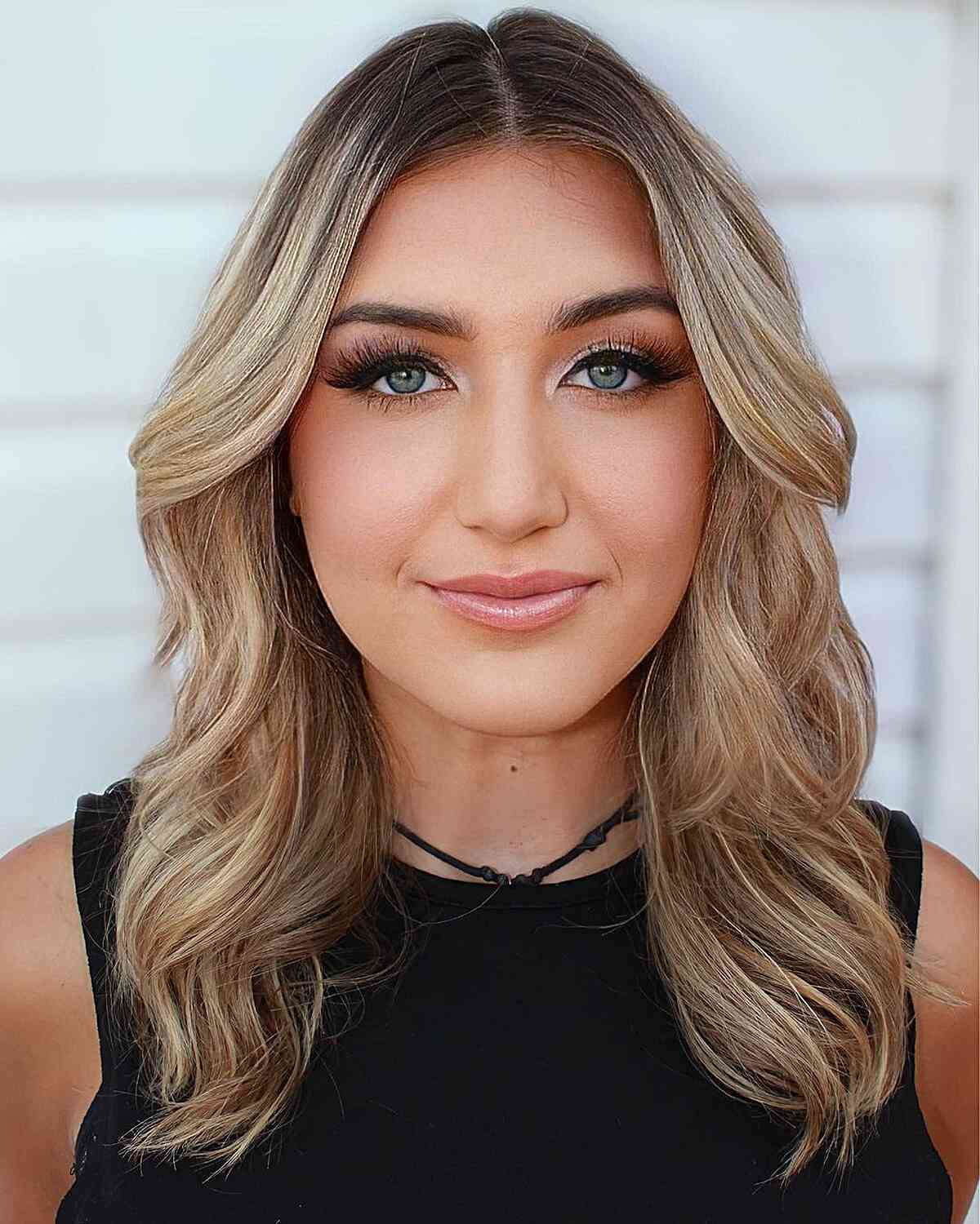 Rooted Blonde Hair with Classic Middle Part Waves for Prom Down Hairstyle