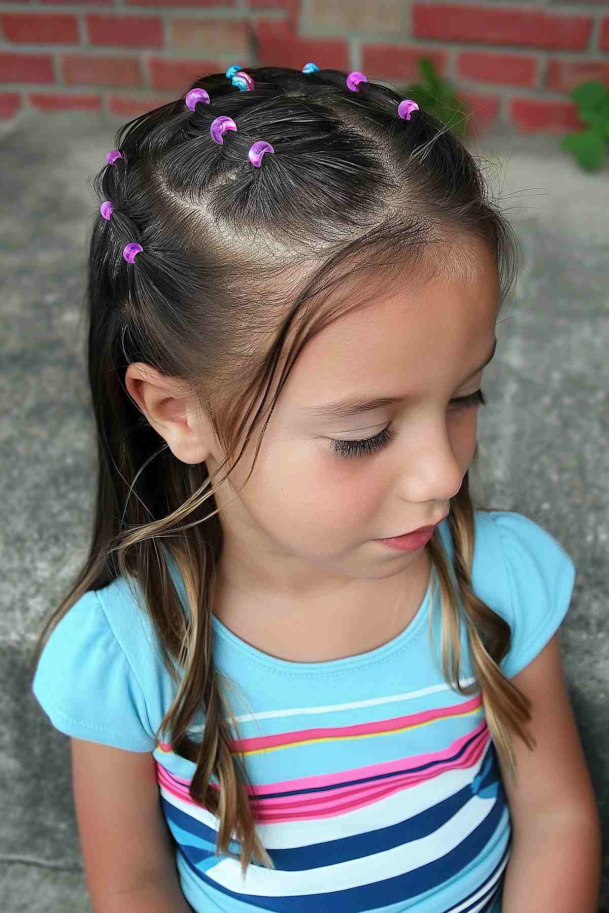 Young girl with rubber band accent braids hairstyle